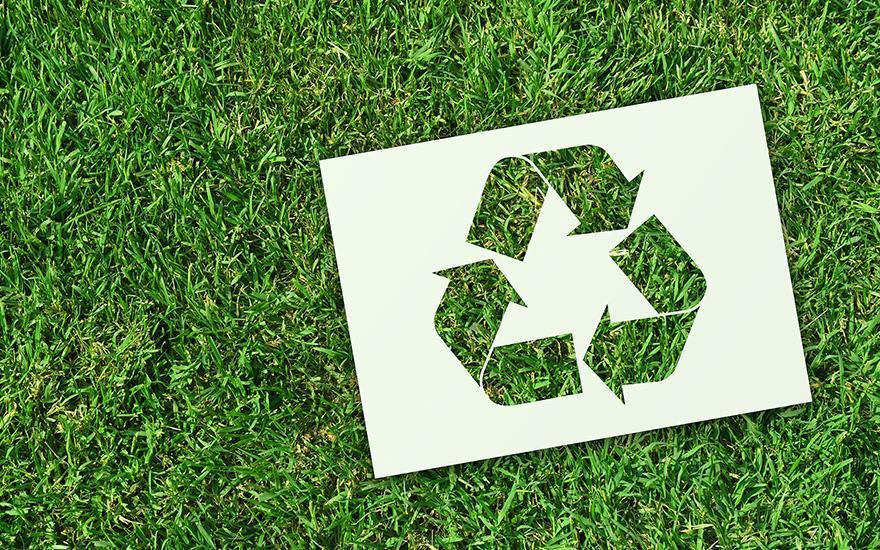 Znak recyklingu na trawie